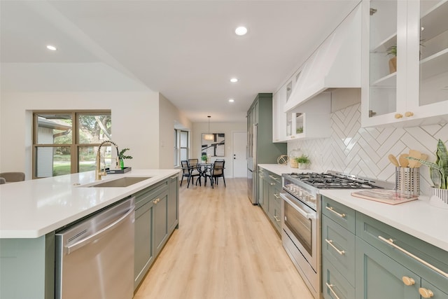 520 Oakcrest Dr, Coppell, TX 75019 - kitchen with stainless steel appliances, green cabinetry, a sink, light countertops, and recessed lighting