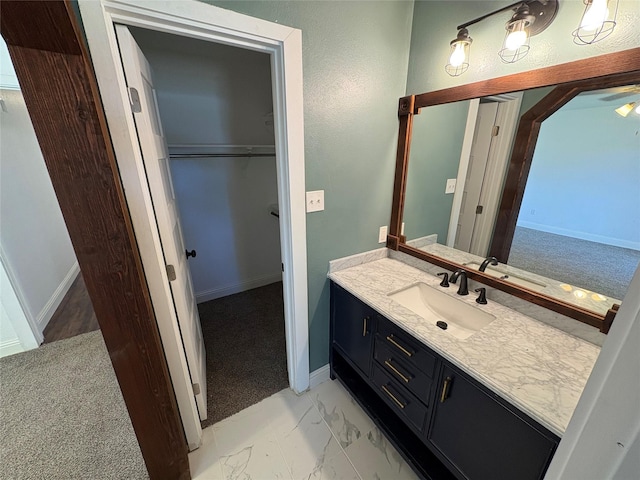 6805 Eagle Rock Dr, Fort Worth, TX 76133 - bathroom with vanity, marble look tile flooring, baseboards, and a spacious closet