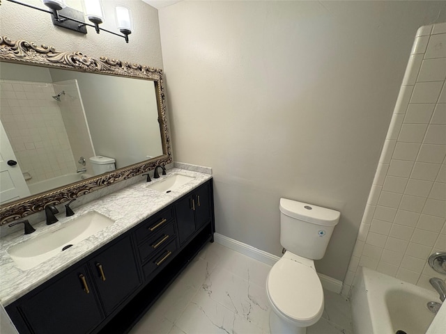 6805 Eagle Rock Dr, Fort Worth, TX 76133 - full bathroom with toilet, double vanity, tub / shower combination, marble look tile flooring, and baseboards