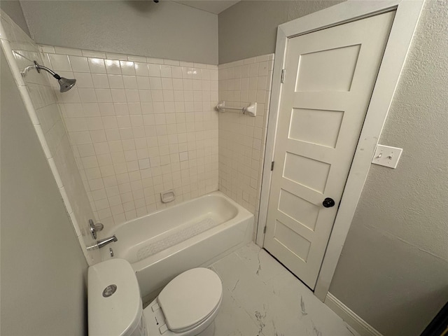 6805 Eagle Rock Dr, Fort Worth, TX 76133 - bathroom featuring marble look tiles, toilet, a textured wall, and tub / shower combination