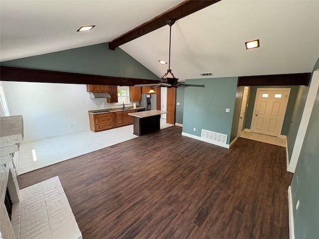 6805 Eagle Rock Dr, Fort Worth, TX 76133 - unfurnished living room featuring ceiling fan, a brick fireplace, beamed ceiling, wood finished floors, and baseboards