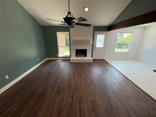 6805 Eagle Rock Dr, Fort Worth, TX 76133 - unfurnished living room with a ceiling fan, a brick fireplace, vaulted ceiling, baseboards, and dark wood-style floors