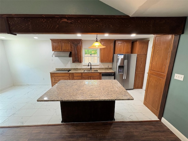 6805 Eagle Rock Dr, Fort Worth, TX 76133 - kitchen with stainless steel appliances, under cabinet range hood, a sink, brown cabinetry, and recessed lighting