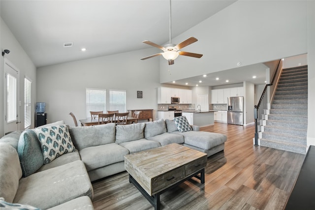 5637 Castle Peak Bnd, Fort Worth, TX 76126 - living room featuring ceiling fan, stairs, high vaulted ceiling, light wood-style flooring, and recessed lighting