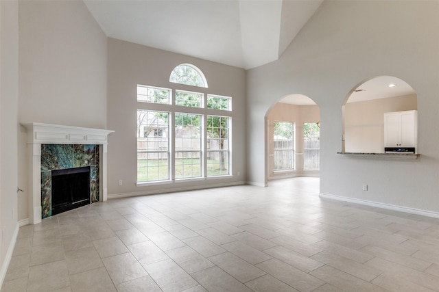 5312 Bellis Dr, Fort Worth, TX 76244 - unfurnished living room with high vaulted ceiling, baseboards, and a high end fireplace