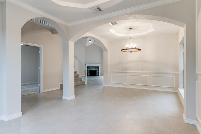5312 Bellis Dr, Fort Worth, TX 76244 - unfurnished room with a tray ceiling, stairway, arched walkways, a decorative wall, and a chandelier
