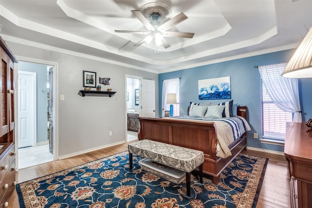 1520 Papeete Dr, Plano, TX 75075 - bedroom with a raised ceiling, wood finished floors, ensuite bathroom, and baseboards