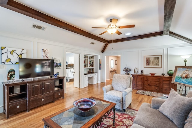 1520 Papeete Dr, Plano, TX 75075 - living area with light wood-type flooring, a ceiling fan, built in features, and a decorative wall