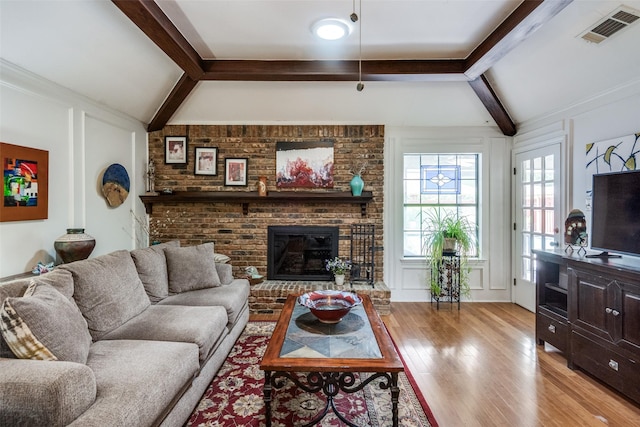 1520 Papeete Dr, Plano, TX 75075 - living area featuring light wood-style floors, a fireplace, and a decorative wall