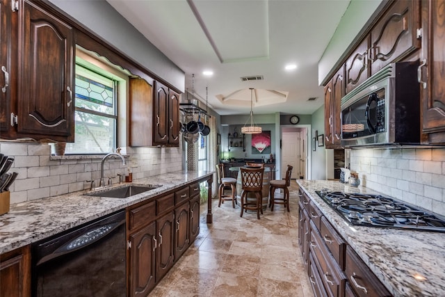 1520 Papeete Dr, Plano, TX 75075 - kitchen featuring black appliances, a sink, tasteful backsplash, and light stone countertops