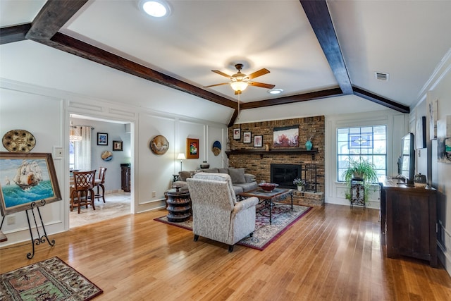 1520 Papeete Dr, Plano, TX 75075 - living room featuring a ceiling fan, light wood-style flooring, a fireplace, and a decorative wall