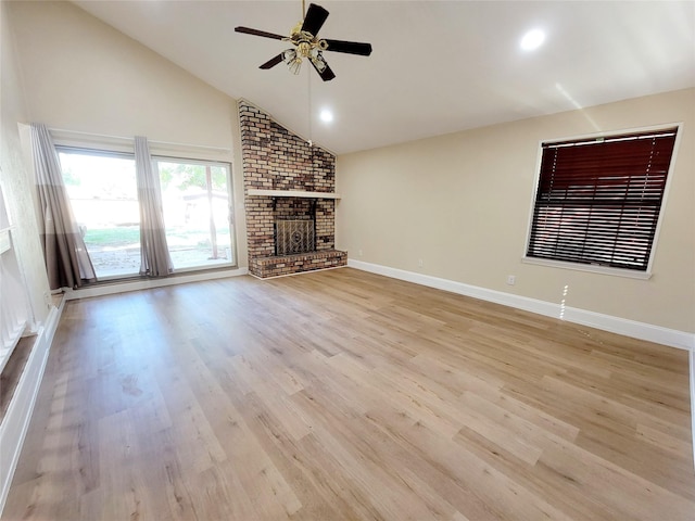 2905 E Park Blvd, Plano, TX 75074 - unfurnished living room featuring a fireplace, a ceiling fan, wood finished floors, lofted ceiling, and baseboards