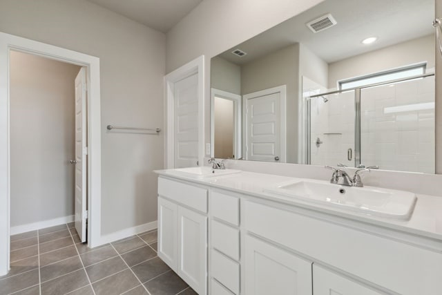 2745 Lopice Ln, Fort Worth, TX 76179 - bathroom with a stall shower, double vanity, tile patterned floors, and baseboards