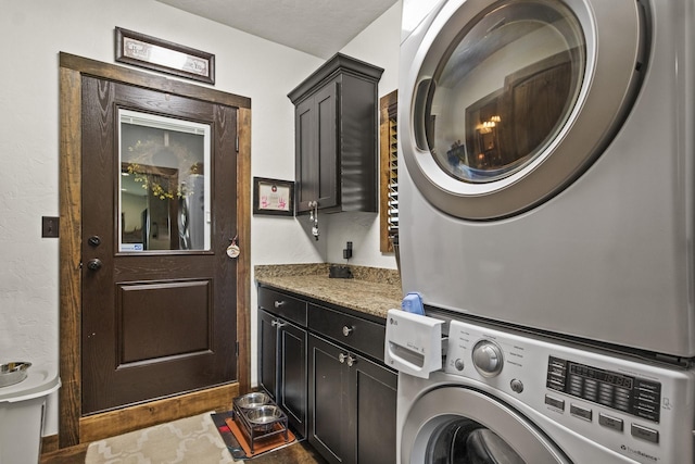 1057 Silver Lake Cir, Mount Pleasant, TX 75455 - laundry area featuring stacked washer / dryer and cabinet space