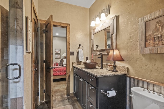 1057 Silver Lake Cir, Mount Pleasant, TX 75455 - ensuite bathroom featuring a textured wall, vanity, toilet, concrete flooring, and a shower with door