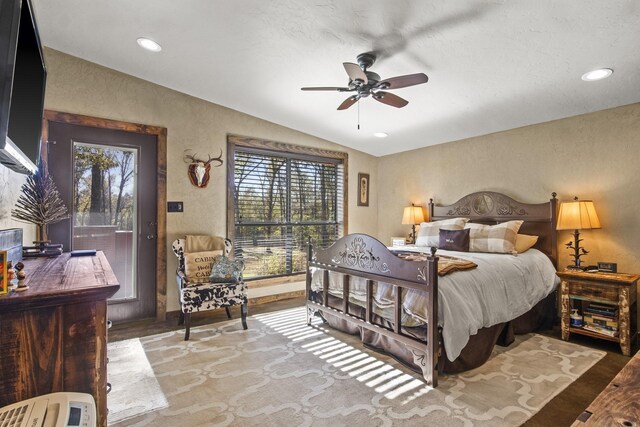1057 Silver Lake Cir, Mount Pleasant, TX 75455 - bedroom with vaulted ceiling, multiple windows, a textured wall, wood finished floors, and recessed lighting
