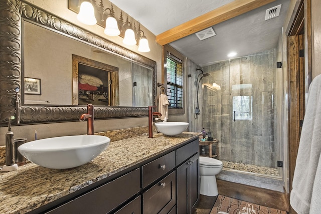 1057 Silver Lake Cir, Mount Pleasant, TX 75455 - bathroom featuring a shower stall, double vanity, and toilet