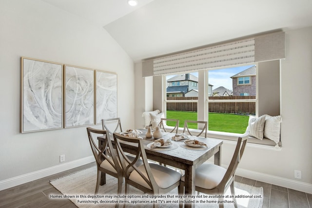 409 Atlas Cedar Dr, Glenn Heights, TX 75154 - dining room featuring vaulted ceiling, wood tiled floors, and baseboards