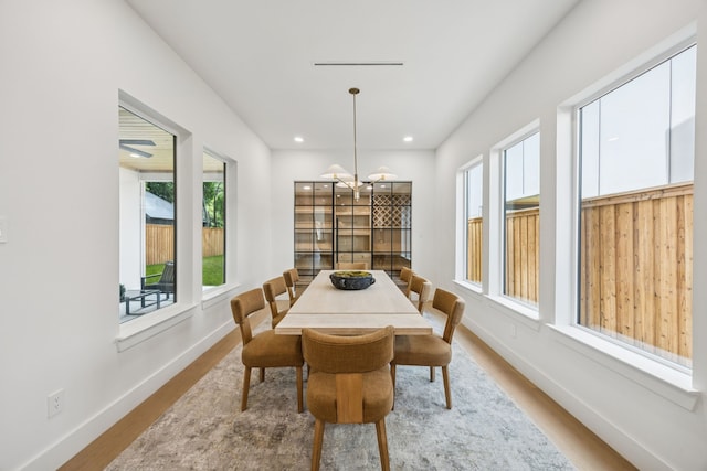 6244 Richmond Ave, Dallas, TX 75214 - dining space with a chandelier, wood finished floors, baseboards, and recessed lighting