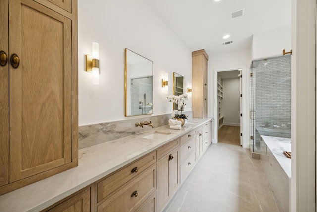 6244 Richmond Ave, Dallas, TX 75214 - full bathroom with a stall shower, vanity, a garden tub, a spacious closet, and tile patterned floors