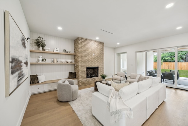 6244 Richmond Ave, Dallas, TX 75214 - living room featuring light wood-style floors, a brick fireplace, recessed lighting, and baseboards