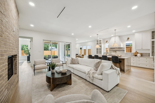 6244 Richmond Ave, Dallas, TX 75214 - living area with light wood-style flooring, recessed lighting, and a fireplace