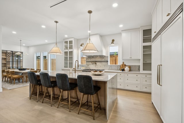 6244 Richmond Ave, Dallas, TX 75214 - kitchen featuring paneled built in fridge, light wood-style floors, white cabinets, plenty of natural light, and recessed lighting
