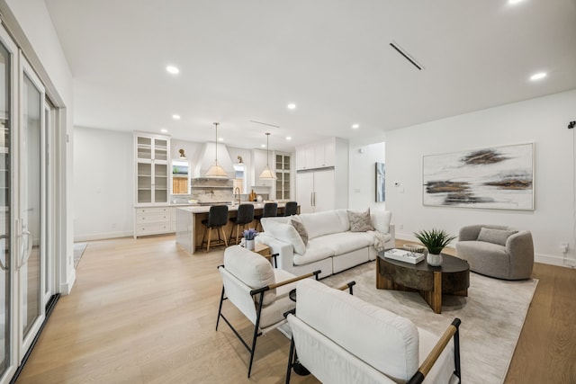 6244 Richmond Ave, Dallas, TX 75214 - living room featuring recessed lighting, light wood-style flooring, and baseboards
