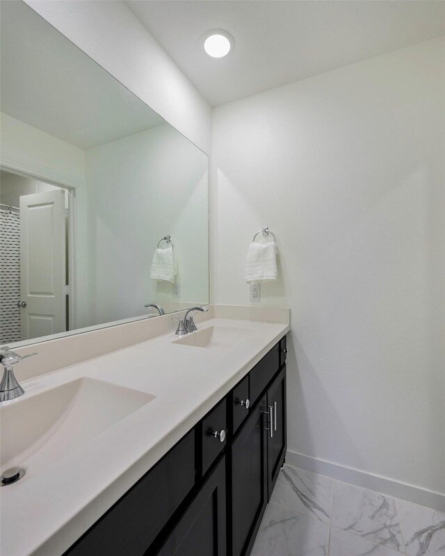 363 Somerville Dr, Mckinney, TX 75071 - bathroom featuring baseboards, double vanity, and marble finish flooring