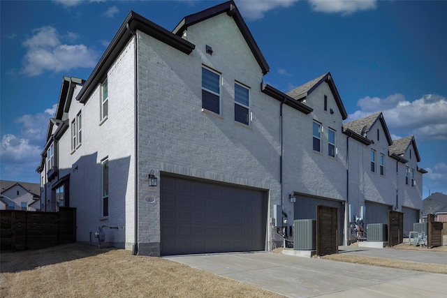 363 Somerville Dr, Mckinney, TX 75071 - rear view of house with a garage, a residential view, driveway, and central AC unit