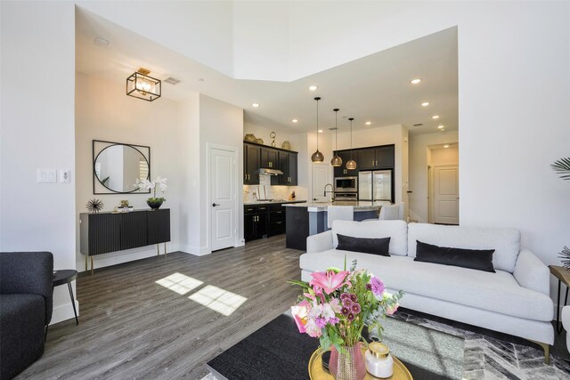 363 Somerville Dr, Mckinney, TX 75071 - living area featuring wood finished floors, recessed lighting, baseboards, and a towering ceiling