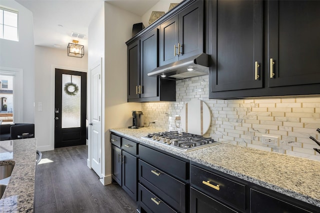 363 Somerville Dr, Mckinney, TX 75071 - kitchen featuring stainless steel gas stovetop, under cabinet range hood, dark wood-type flooring, tasteful backsplash, and light stone counters