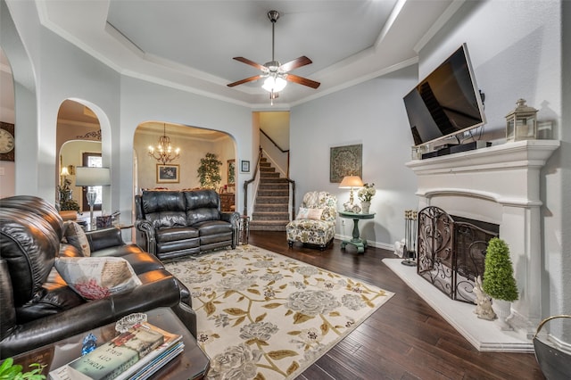 2705 Pioneer Dr, Denton, TX 76210 - living room featuring a tray ceiling, arched walkways, stairway, a fireplace with raised hearth, and crown molding