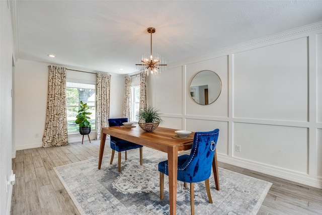 2617 Beechmont Dr, Dallas, TX 75228 - dining area with a decorative wall, light wood-type flooring, a chandelier, crown molding, and baseboards