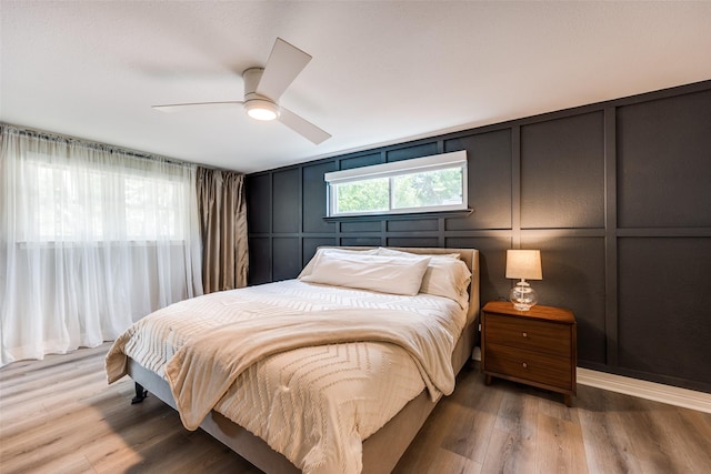 2617 Beechmont Dr, Dallas, TX 75228 - bedroom featuring a decorative wall, wood finished floors, and ceiling fan