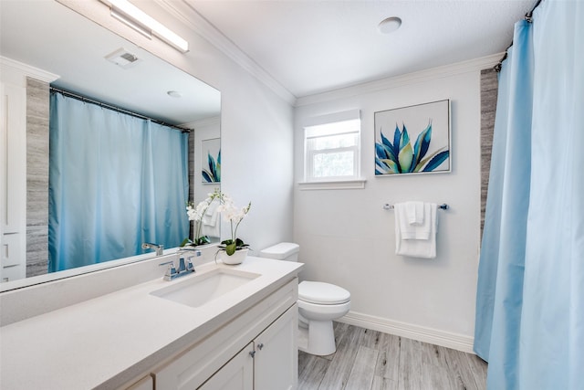 2617 Beechmont Dr, Dallas, TX 75228 - full bathroom featuring toilet, vanity, ornamental molding, baseboards, and wood finished floors