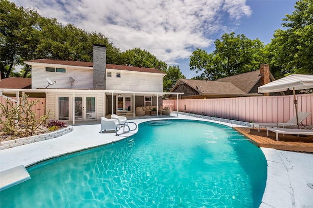2617 Beechmont Dr, Dallas, TX 75228 - view of pool with outdoor lounge area, a fenced backyard, a diving board, french doors, and a wooden deck