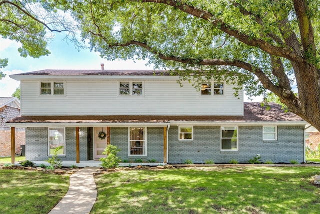 2617 Beechmont Dr, Dallas, TX 75228 - traditional home with brick siding, a porch, and a front yard