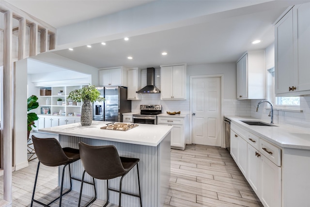 2617 Beechmont Dr, Dallas, TX 75228 - kitchen featuring wall chimney range hood, appliances with stainless steel finishes, a sink, a kitchen bar, and a center island