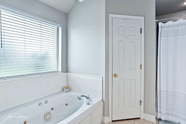 2198 Stockwell Rd, Bossier City, LA 71111 - full bath featuring a whirlpool tub, tile patterned floors, and baseboards