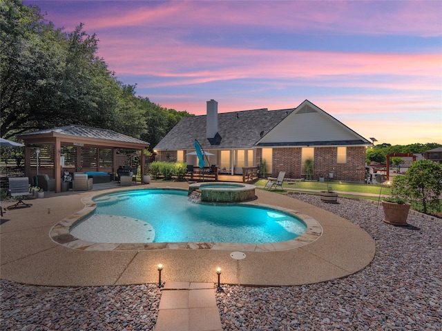 4710 Ashley Cir, Midlothian, TX 76065 - pool at dusk featuring a gazebo, a patio, a pool with connected hot tub, and outdoor lounge area
