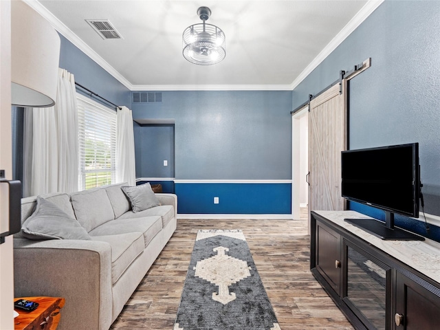4710 Ashley Cir, Midlothian, TX 76065 - living area with a barn door, ornamental molding, and wood finished floors