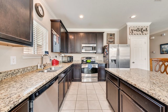 10237 Pyrite Dr, Fort Worth, TX 76131 - kitchen featuring stainless steel appliances, a sink, crown molding, dark brown cabinetry, and light stone counters