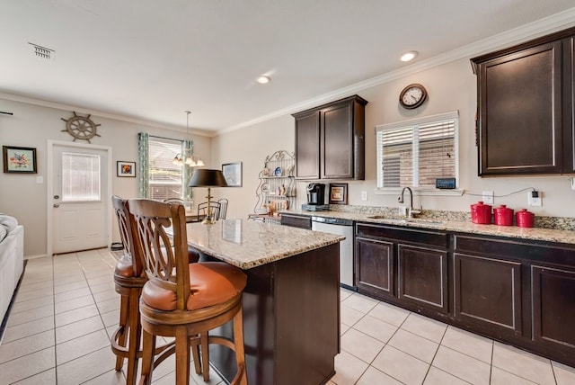 10237 Pyrite Dr, Fort Worth, TX 76131 - kitchen with a sink, dishwasher, light tile patterned floors, a breakfast bar, and crown molding
