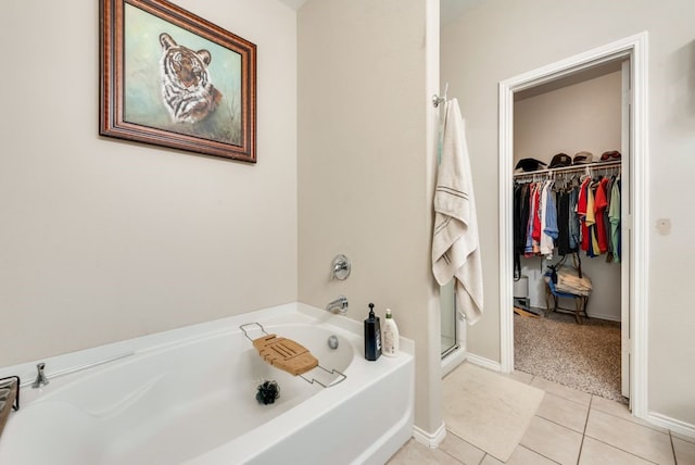 10237 Pyrite Dr, Fort Worth, TX 76131 - full bath with a garden tub, tile patterned flooring, a walk in closet, a stall shower, and baseboards