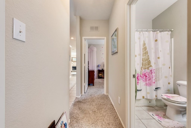 10237 Pyrite Dr, Fort Worth, TX 76131 - hallway featuring light colored carpet and light tile patterned floors