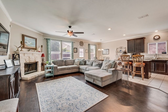 10237 Pyrite Dr, Fort Worth, TX 76131 - living area featuring ceiling fan, a stone fireplace, crown molding, light wood-style flooring, and recessed lighting