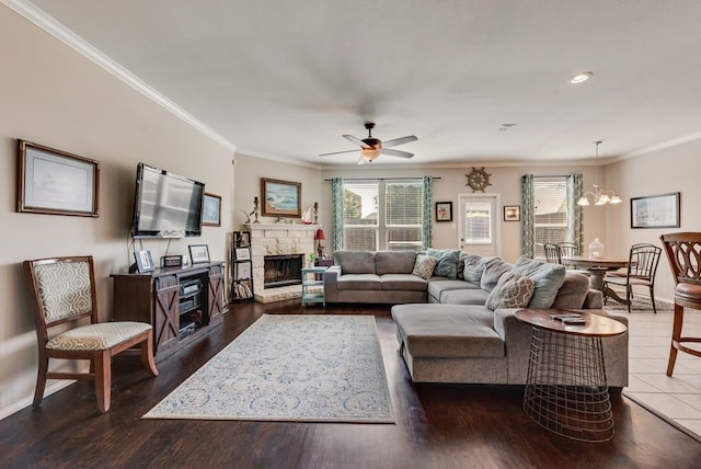 10237 Pyrite Dr, Fort Worth, TX 76131 - living room featuring ornamental molding, a ceiling fan, a chandelier, a stone fireplace, and recessed lighting