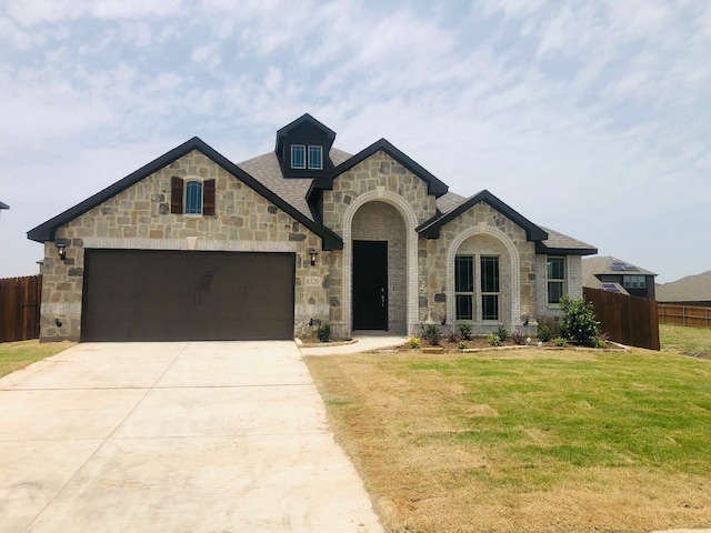 6320 Dartford Dr, Mesquite, TX 75181 - french provincial home featuring stone siding, an attached garage, and driveway