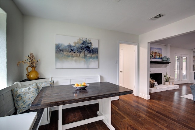 1220 Melony Dr, Sulphur Springs, TX 75482 - dining space featuring wood finished floors, a fireplace, and baseboards